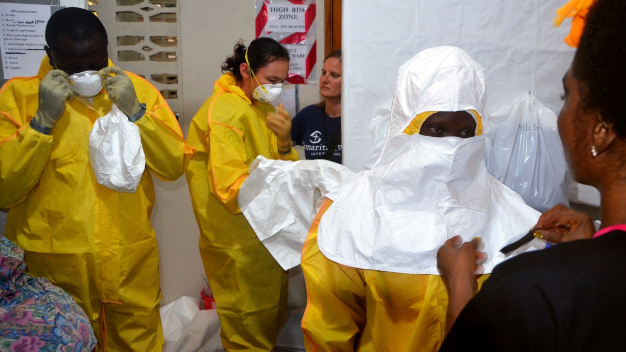 Imagem mostra profissionais de saúde na Libéria protegidos para evitar o contágio pelo vírus Ebola