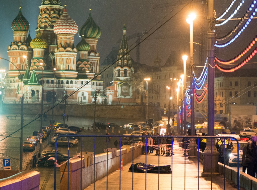 Corpo do opositor russo Boris Nemtsov é visto coberto por um saco plástico preto na ponte Moskvoretsky, perto da Catedral de São Basílio (ao fundo), na Praça Vermelha