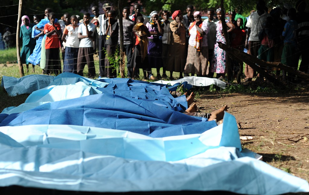 Moradores da cidade queniana de Mpeketoni observam corpos após atentado durante transmissão de jogo da Copa do Mundo