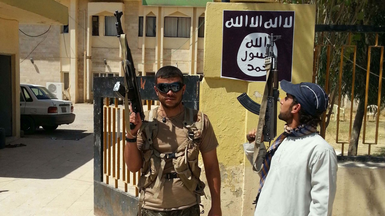 Terroristas do EIIL montam guarda após batalha com as forças governistas do Iraque