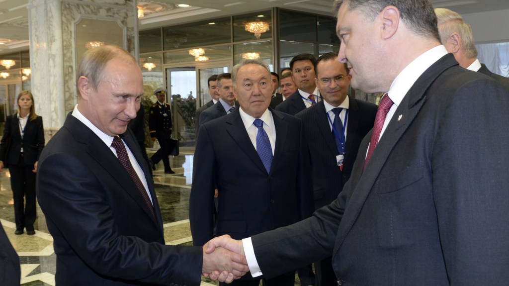 O presidente russo, Vladimir Putin, cumprimenta o mandatário ucraniano, Petro Poroshenko