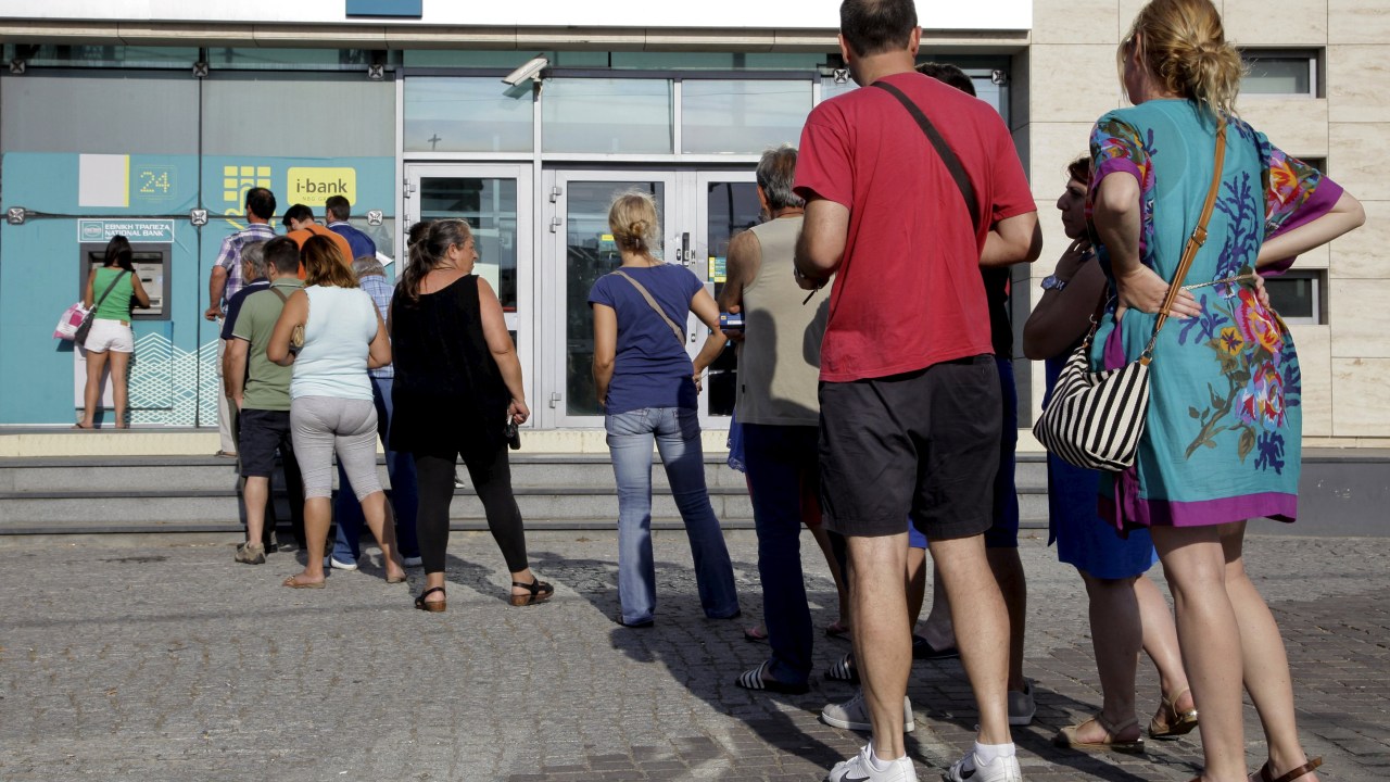 Gregos fazem fila para sacar dinheiro antes do início do regime de controle de capitais