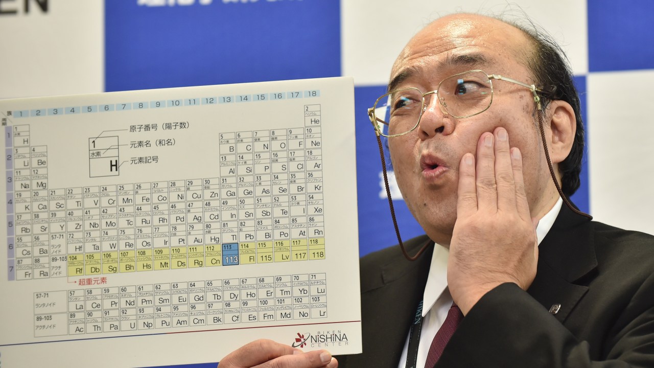 Kosuke Morita, líder da equipe Riken, posa com uma placa exibindo o novo elemento atômico 113, durante coletiva de imprensa em Wako, no Japão