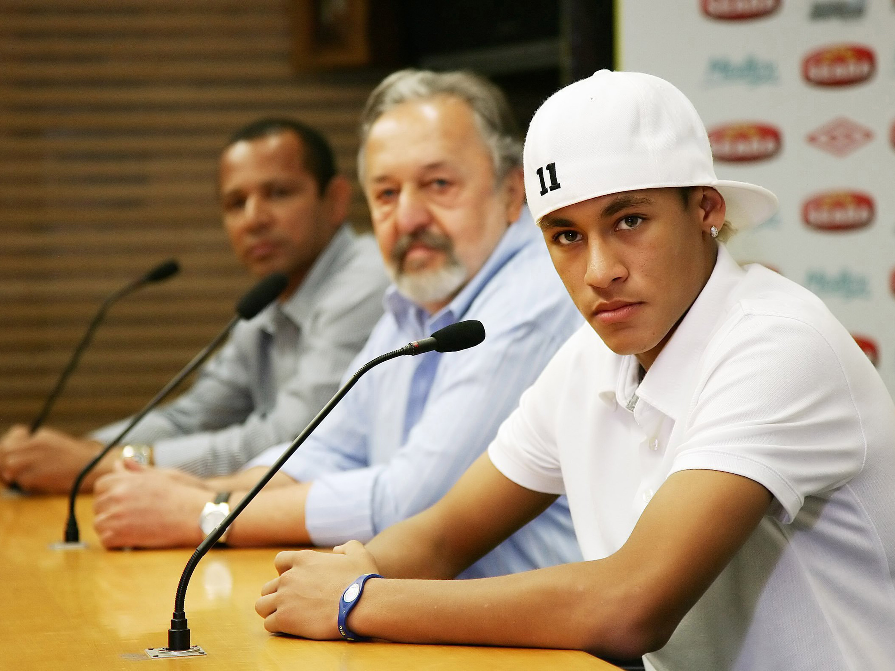 Da esq. para a dir., Neymar da Silva Santos, pai do jogador Neymar, Luis Álvaro de Oliveira Ribeiro, então presidente do Santos, e Neymar, durante coletiva sobre a permanência do atacante no Santos em 2014