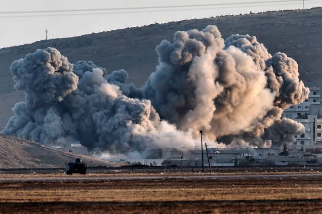 Fumaça é vista durante ataques aéreos na cidade síria de Ain al-Arab, visto a partir da fronteira com a Turquia. O Pentágono anunciou hoje (08) que o poder aéreo dos Estados Unidos por si só não pode impedir que os jihadistas do Estado Islâmico (EI) avancem sobre a cidade fronteiriça de Kobane