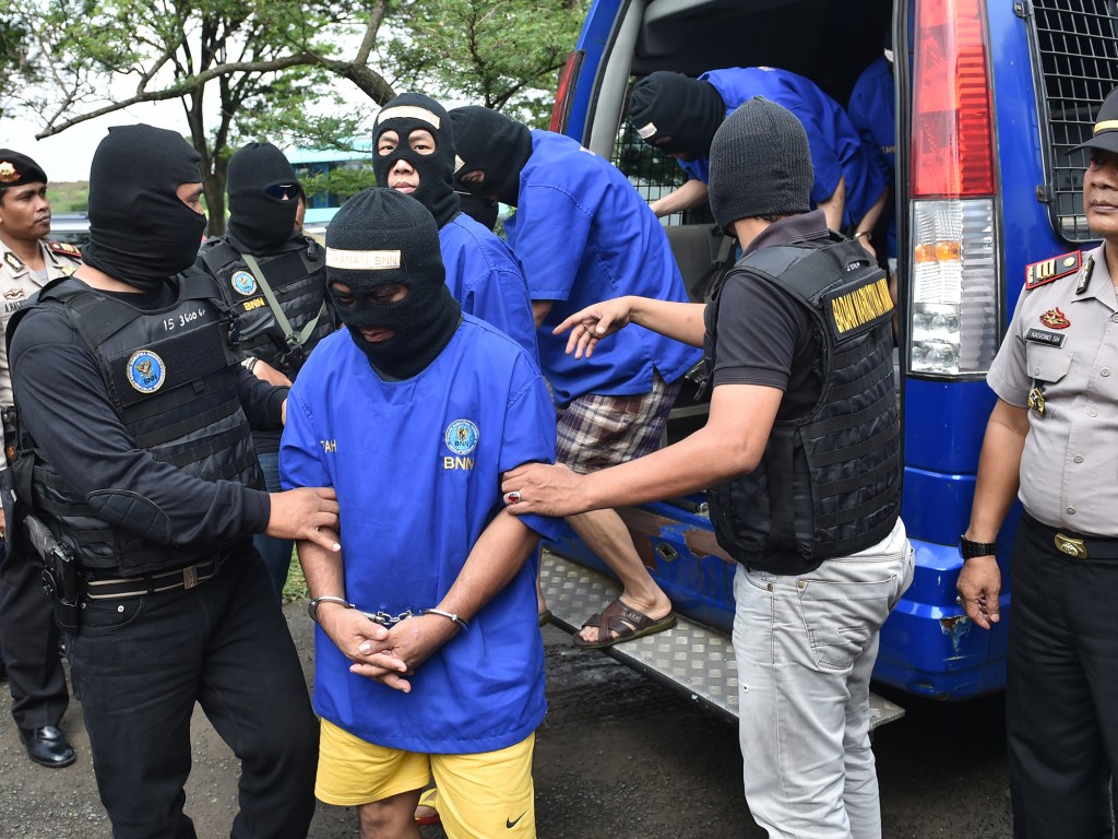 Traficantes internacionais de drogas, incluindo o coreano Wong Chi Ping, são escoltados pela polícia para uma cerimônia para queimar alguns dos 862 kg de metanfetamina apreendidos em Tangerang, nos subúrbios de Jacarta, na Indonésia