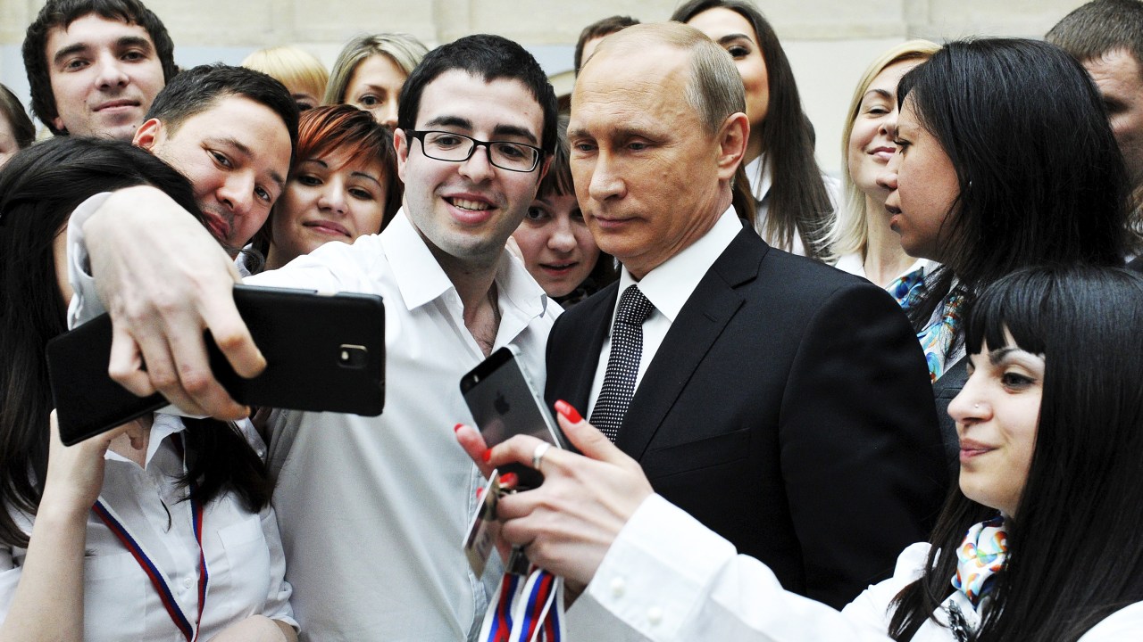 O presidente russo, Vladimir Putin posa para uma foto com funcionários de um call center depois de um pronunciamento em rede nacional em Moscou - 16/04/2015