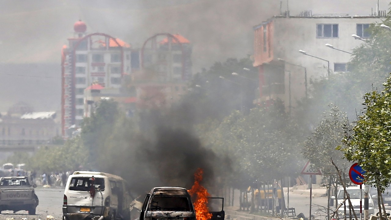 Veículo em chamas é fotografado próximo ao parlamento do Afeganistão, em Cabul, após explosão atingir o local. Os sete criminosos talibãs responsáveis pelo ataque acabaram mortos, um se matou ao explodir um carro e outros seis foram mortos por forças locais de segurança - 22/06/2015