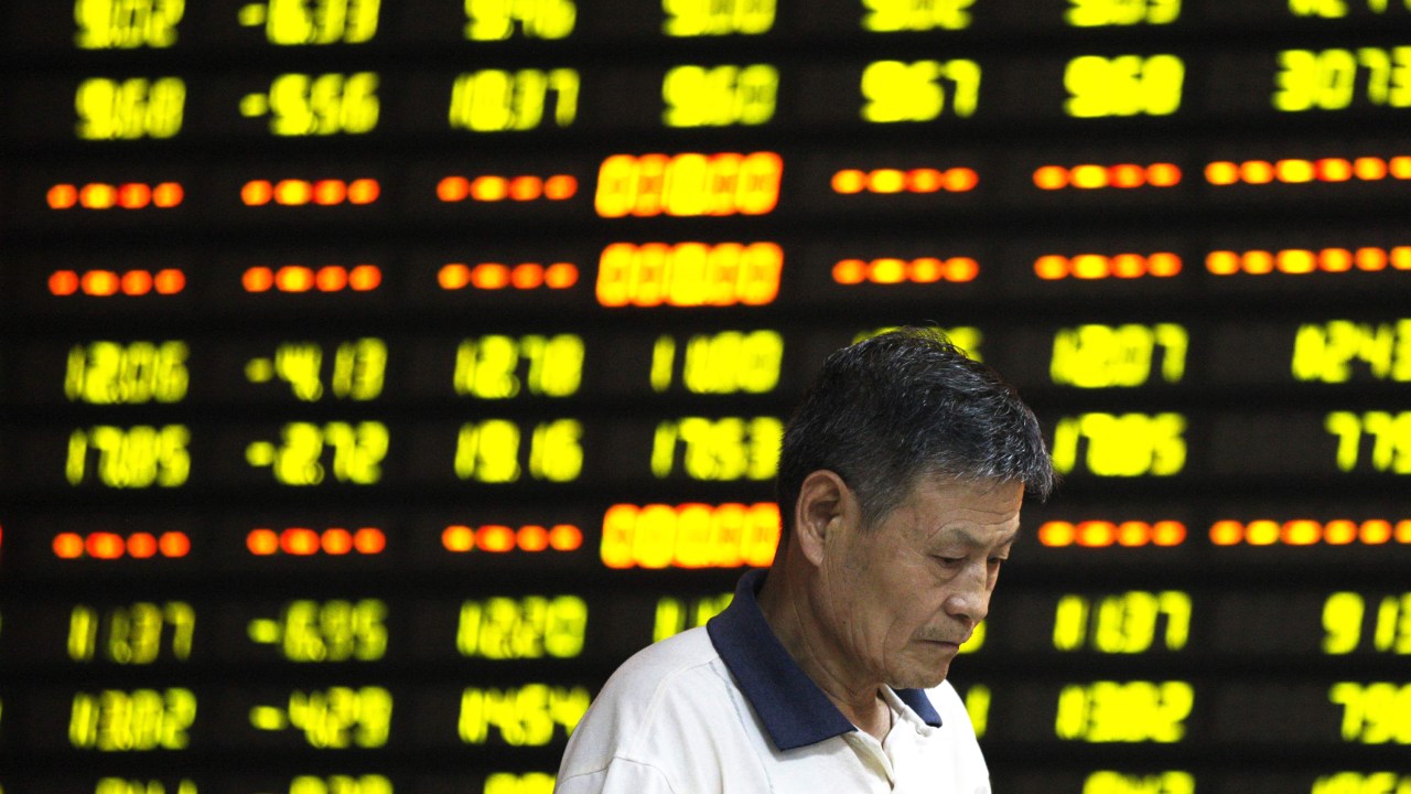 Investidor é visto em frente ao painel eletrônico com informações da bolsa, em uma corretora de Huaibei, na China. As ações no país caíram mais de 8%, sua maior queda em um dia em mais de oito anos - 27/07/2015