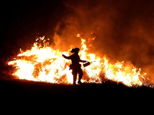 Bombeiro tenta controlar as chamas do incêndio que ficou conhecido como "Rocky Fire", em Clearlake, Califórnia. Cerca de 3.000 bombeiros enfrentam o incêndio que já queimou cerca de 60.000 acres e forçou a evacuação de 12.000 residentes