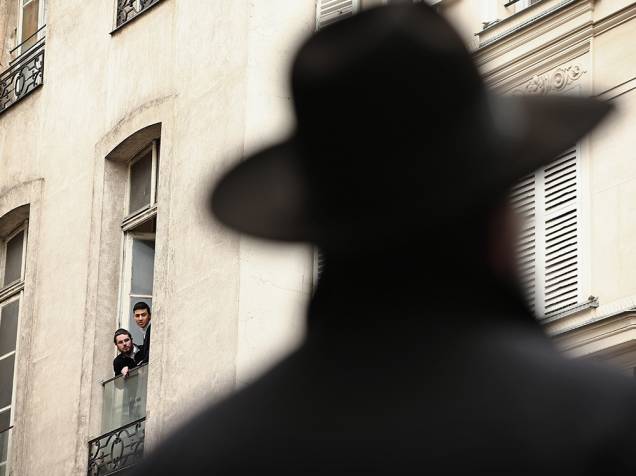 Judeus observam das varandas a circulação de policiais frances que reforçam a segurança no bairro de Marais, em Paris
