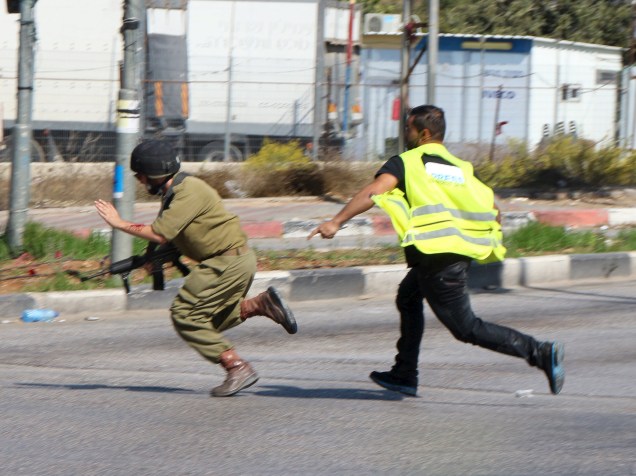 Palestino que se passava por jornalista, corre para atacar com uma faca um soldado israelense perto da cidade de Hebron, Cisjordânia