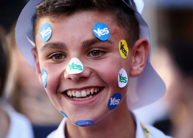 Garoto sorri com vários adesivos pró-independência colados no rosto na cidade de Largs, Escócia - 17/09/2014