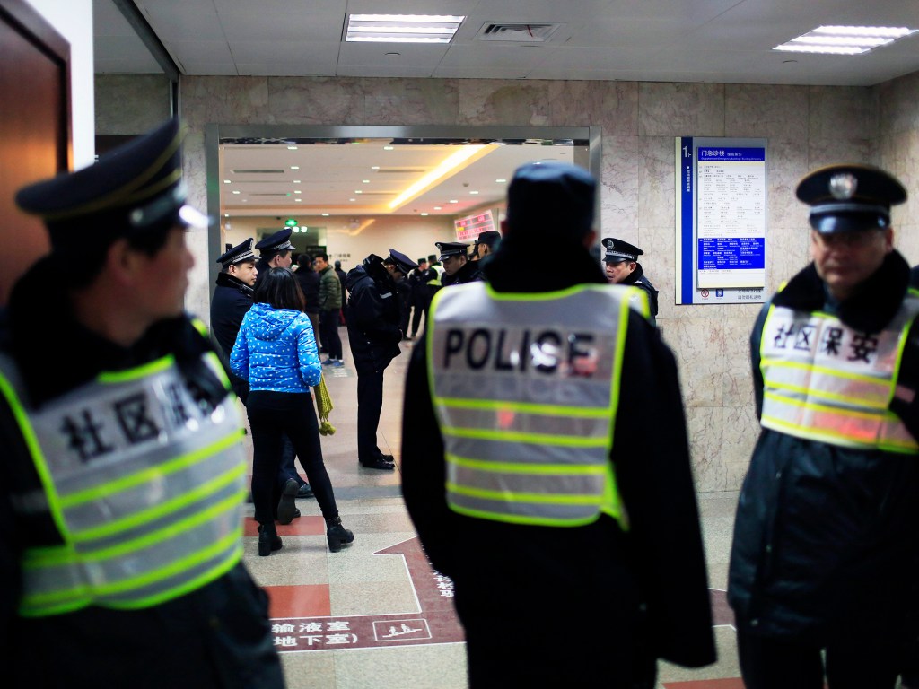 Policiais aguardam em frente a hospital onde vítimas de acidente durante o reveillon são atendidas em Xangai, China