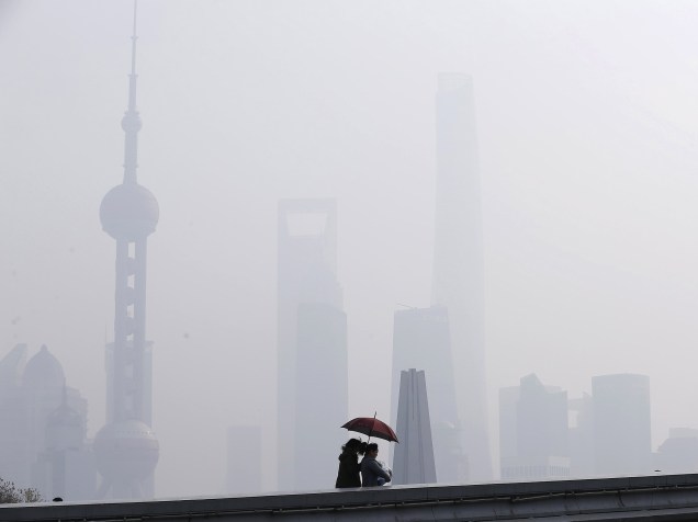 <p>Vista da ponte em frente ao distrito financeiro de Pudong em meio a forte neblina causada pela poluição em Xangai, na China</p>