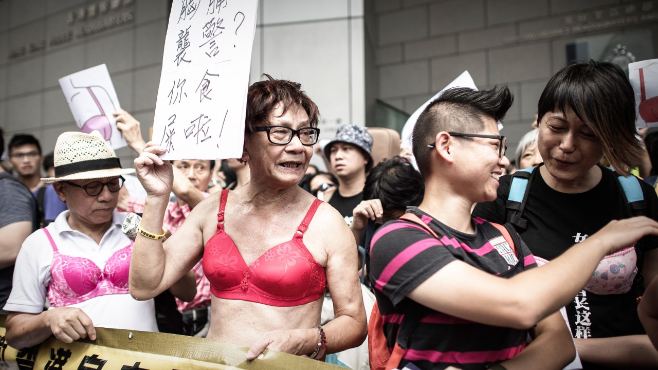 Homens e mulheres protestam em Hong Kong após uma mulher ser presa, segundo a justiça, ela teria agredido um oficial da polícia com seu seio