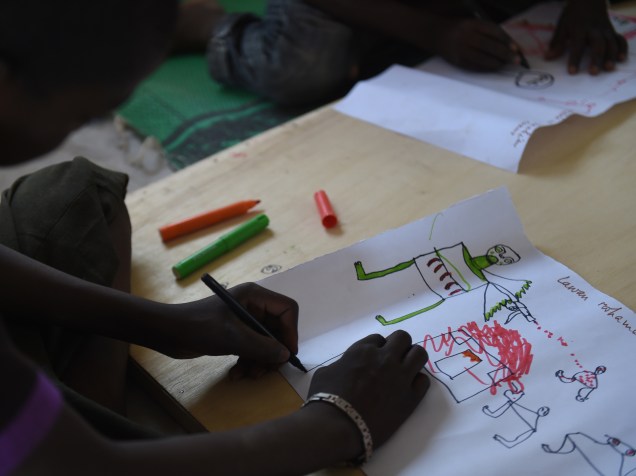 Jovens refugiados desenham cenas de ataque durante programa de terapia da UNICEF, próximo a Baga Sola