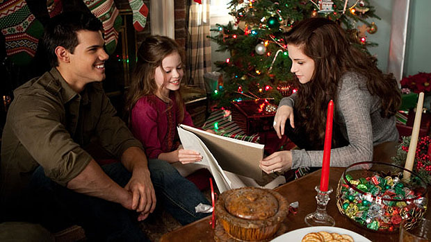 Jacob (Taylor Lautner) na manhã de Natal com Bella (Kristen Stewart) e sua filha Renesmee (Mackenzie Foy) em cena do filme Amanhecer - Parte 2, o capítulo final de Crepúsculo