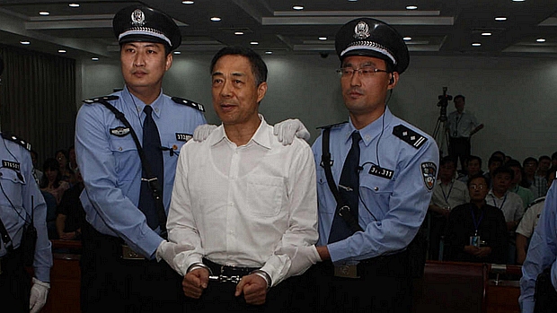 Bo Xilai, algemado e cercado por policiais, ouve o veredicto: imagem emblemática