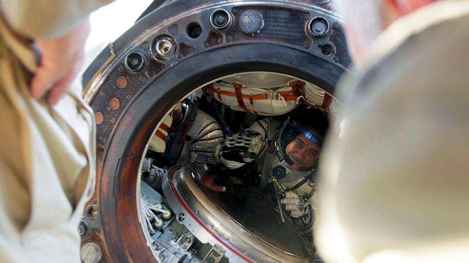 <p>Equipe russa retira astronautas da cápsula espacial Soyuz TMA-08M após pouso cerca de 146 km a sudeste da cidade de Zhezkazgan, no Cazaquistão</p>
