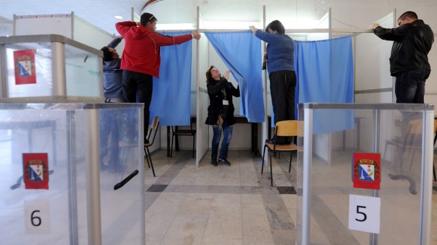 Em Sevastopol, funcinários arrumam local de votação para o referendo do dia 16/03/2014