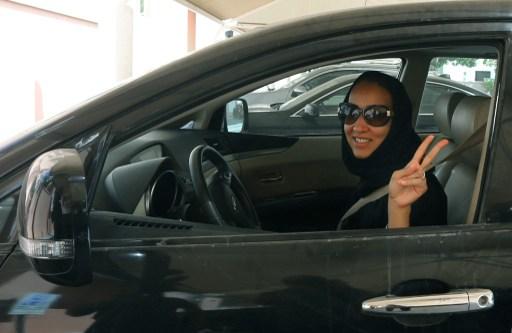A ativista saudita Manal Al Sharif, que vive em Dubai, faz o símbolo da vitória ao dirigir, demonstrando apoio à campanha das mulheres da Arábia Saudita pelo direito de dirigir