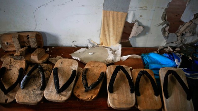 Sapatos tradicionais são deixados em um centro cívico abandonado na área costeira da cidade de Namie
