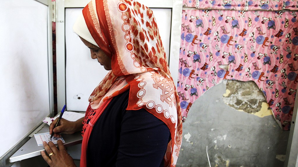 Mulher preenche seu voto durante o primeiro dia de votação na área de Shubra, no Cairo durante as eleições presidenciais no Egito