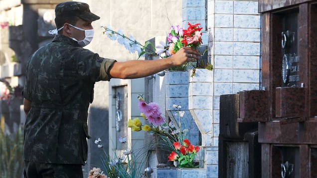Soldados do Exército colocam flores no local onde serão enterrados os corpos de parte das vítimas do incêndio em uma boate na cidade de Santa Maria (RS)