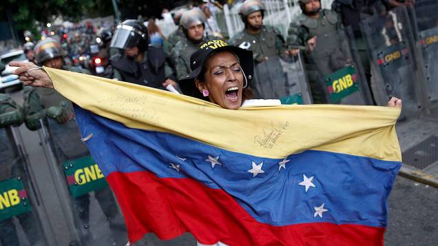 Manifestante de oposição segura uma bandeira da Venezuela, durante um protesto contra o governo do presidente Nicolás Maduro, em Caracas