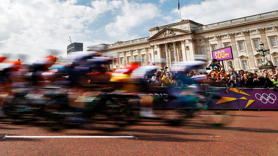Ciclistas passam em frente ao Palácio de Buckingham