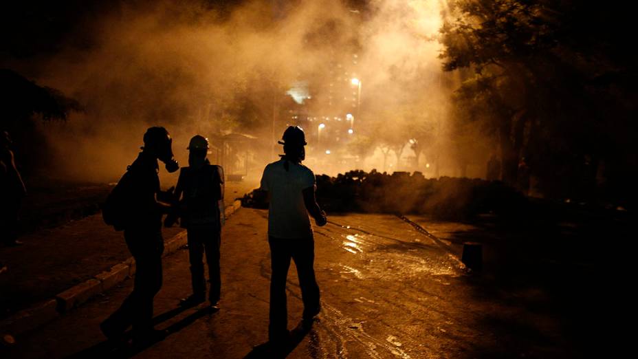 Manifestantes anti-governo são vistos em meio a fumaça de gás lacrimogêneo disparado pela polícia durante os confrontos em Istambul