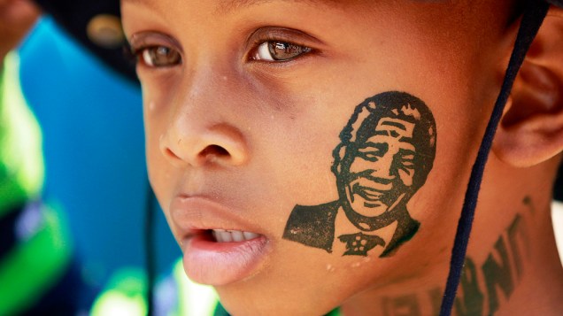 Menino espera para se despedir de Mandela, em Pretória