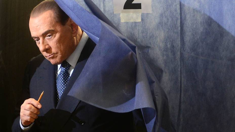 Silvio Berlusconi deixando a cabine de votação, em Milão