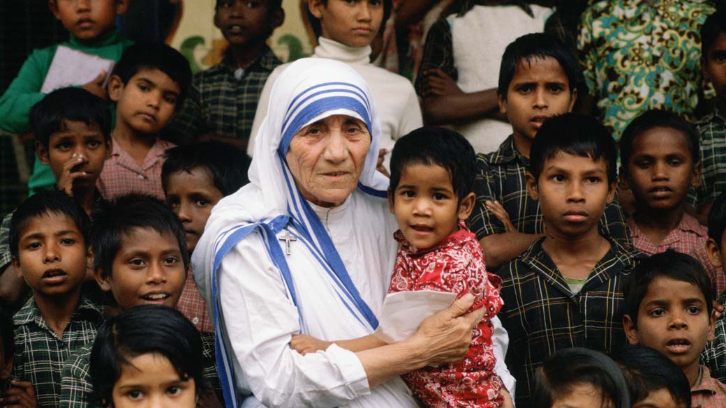 Madre Teresa de Calcutá acompanhada de crianças em sua missão em Calcutá, Índia