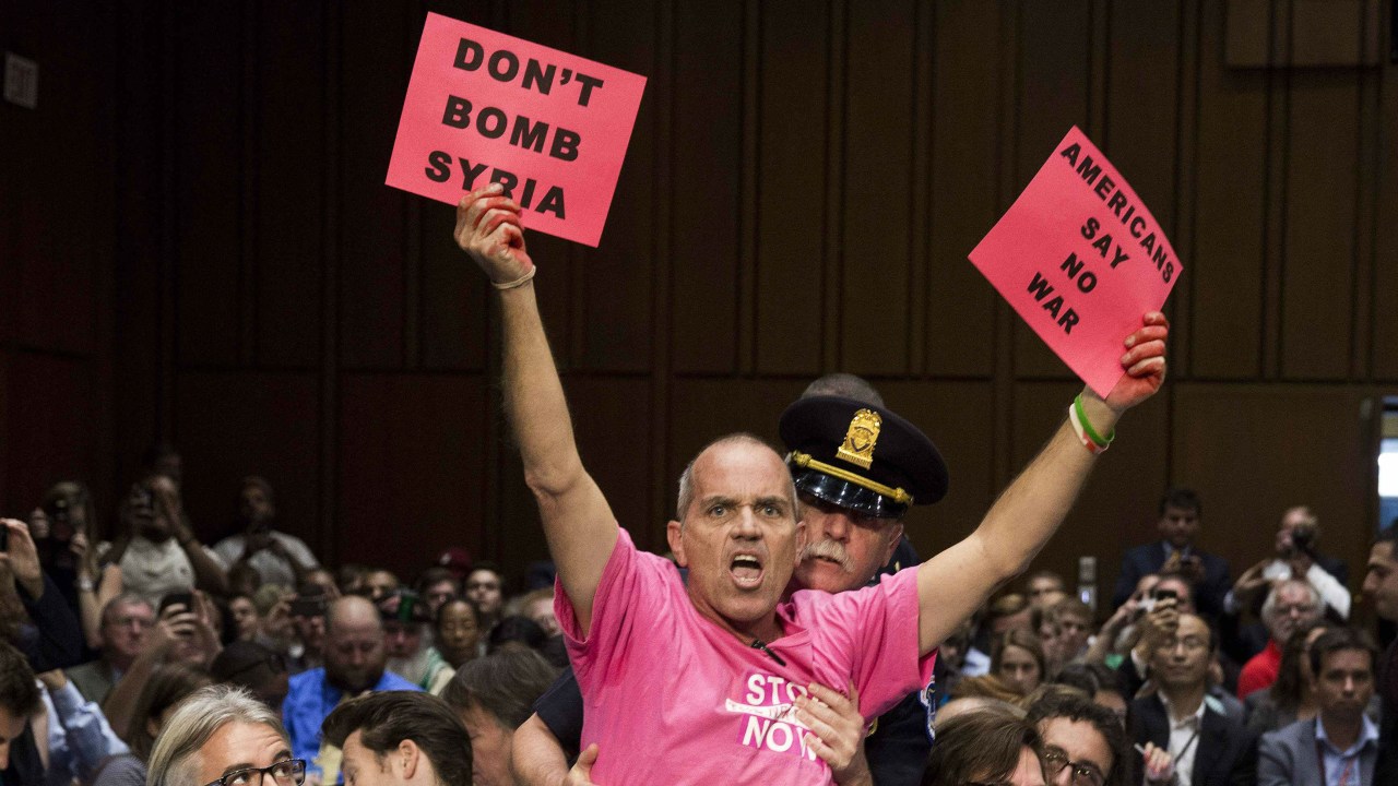 Manifestante protesta contra intervenção americana na guerra civil síria durante audiência no Senado
