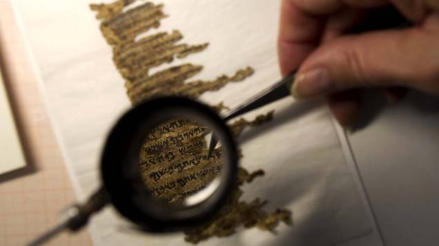 Analista de conservação examina fragmentos dos Manuscritos do Mar Morto, que possuem mais de 2.000 anos de idade e serão publicados online