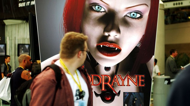 Visitante olha para o cartaz do jogo "Bloodrayne", produzido pela empresa americana Terminal Reality, durante a E3 de 2002