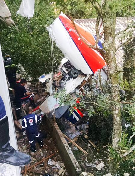 Destroços do helicóptero são vistos sobre um imóvel na Grande São Paulo