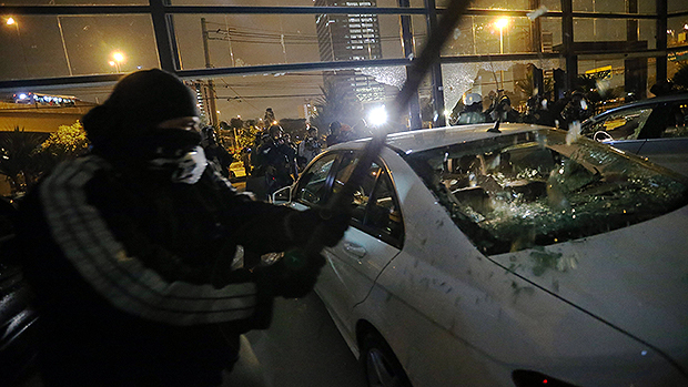 Manifestantes invadem concessionária e depredam carros
