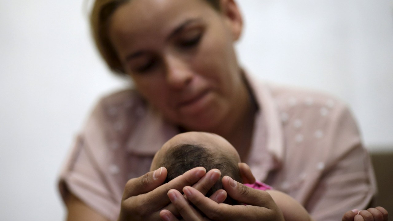 Mãe segura filho que nasceu com microcefalia, no hospital IMIP no Recife
