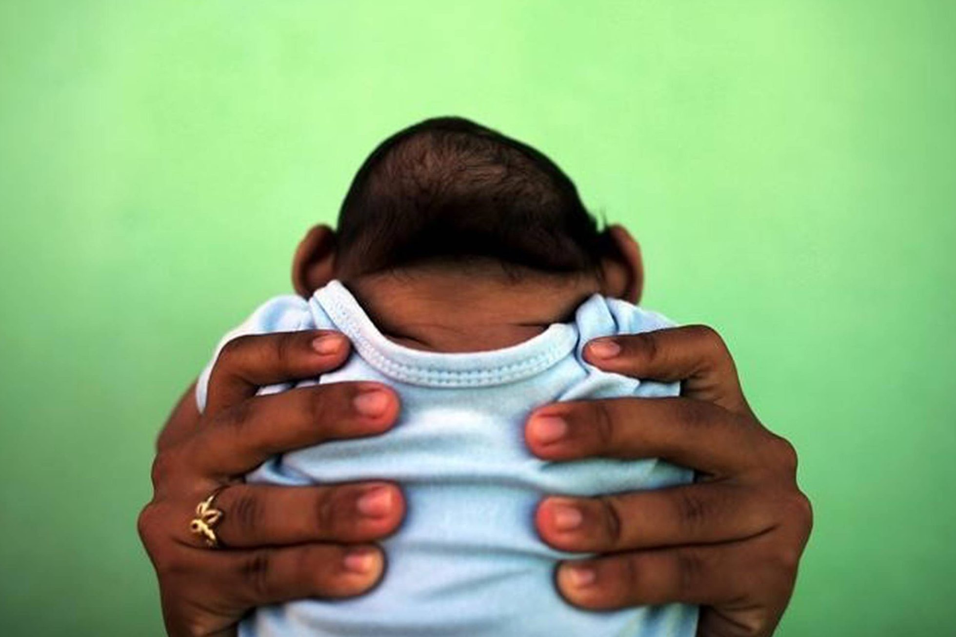 Jackeline, de 26 anos, segura o filho Daniel, de 4 meses, que nasceu com microcefalia em Olinda