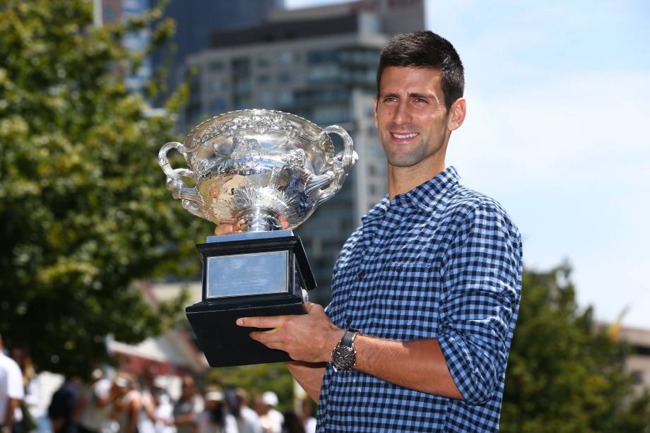 Novak Djokovic posou com o troféu na Universidade de Melbourne nesta segunda-feira