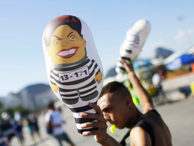 Homem faz propaganda dos "pixulecos", bonecos infláveis com a imagem da Presidente Dilma. Em Copacabana, manifestantes se reúnem para protestar a favor do Impeachment, no Rio de Janeiro - 17/04/2016