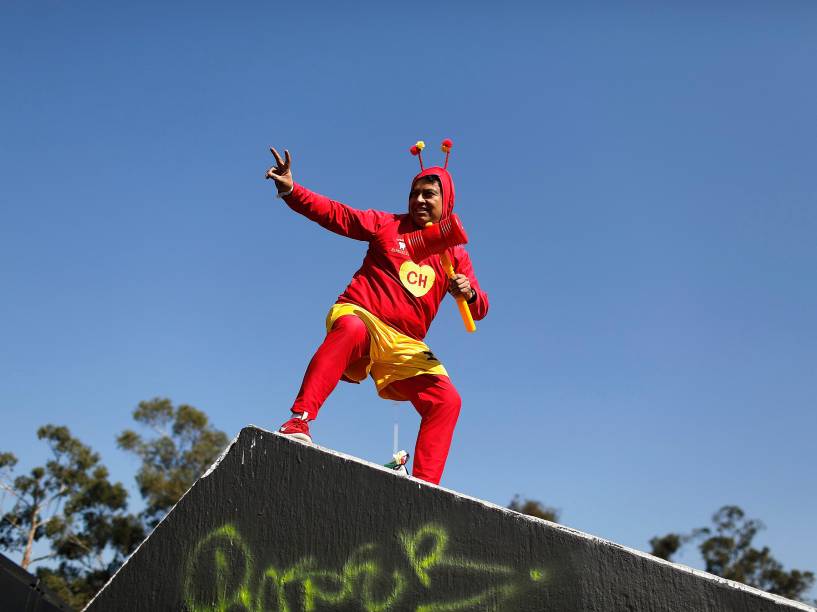 Homem vestido de Chapolin Colorado posa para foto na entrada do estádio Azteca na Cidade do México, antes da missa de corpo presente de Roberto Bolaños - 30/11/2014