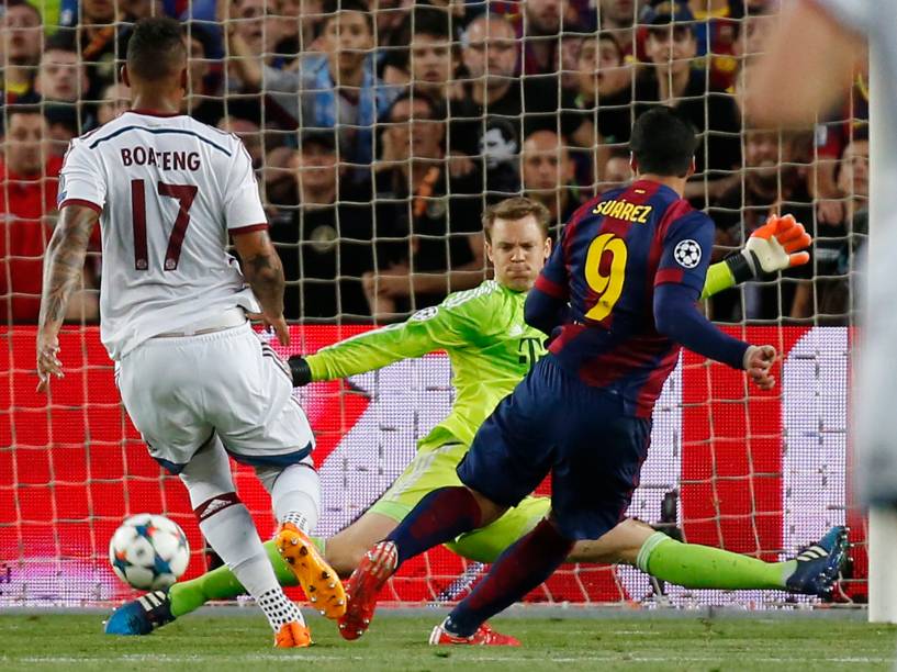O goleiro Neuer do Bayern de Munique defende com os pés a tentativa do atacante uruguaio Luis Suárez do Barcelona