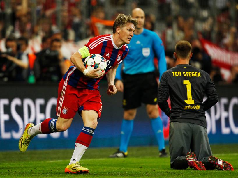 Bastian Schweinsteiger do Bayern de Munique pega a bola após o gol da vitória por 3 a 2 sobre o Barcelona marcado por Thomas Muller