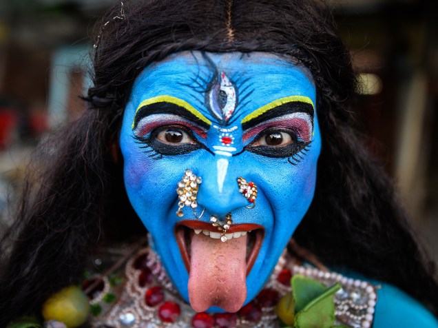 Artista indiano vestido da deusa Hindu, Kali, participa da procissão do festival Ganesh Chaturthi, em Nova Deli, Índia