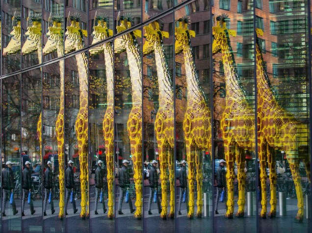 Girafa feita de peças de Lego é refletida em uma parede de vidro, em Berlim, Alemanha 