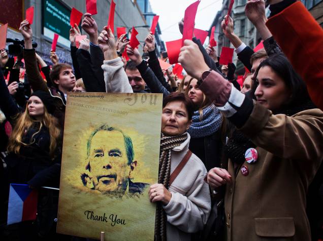 Mulher segura um cartaz com uma foto do ex-presidente da Checoslováquia e da República Checa Vaclav Havel durante protesto contra o atual,  Milos Zeman, perto de um memorial dedicado aos alunos que foram atacados pela polícia de choque em 1989 durante Revolução de Veludo que completa 25 anos, em Praga - 17/11/2014